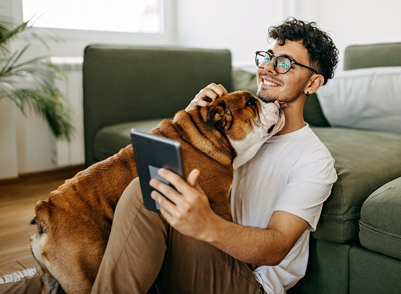 young man cuddling a dog